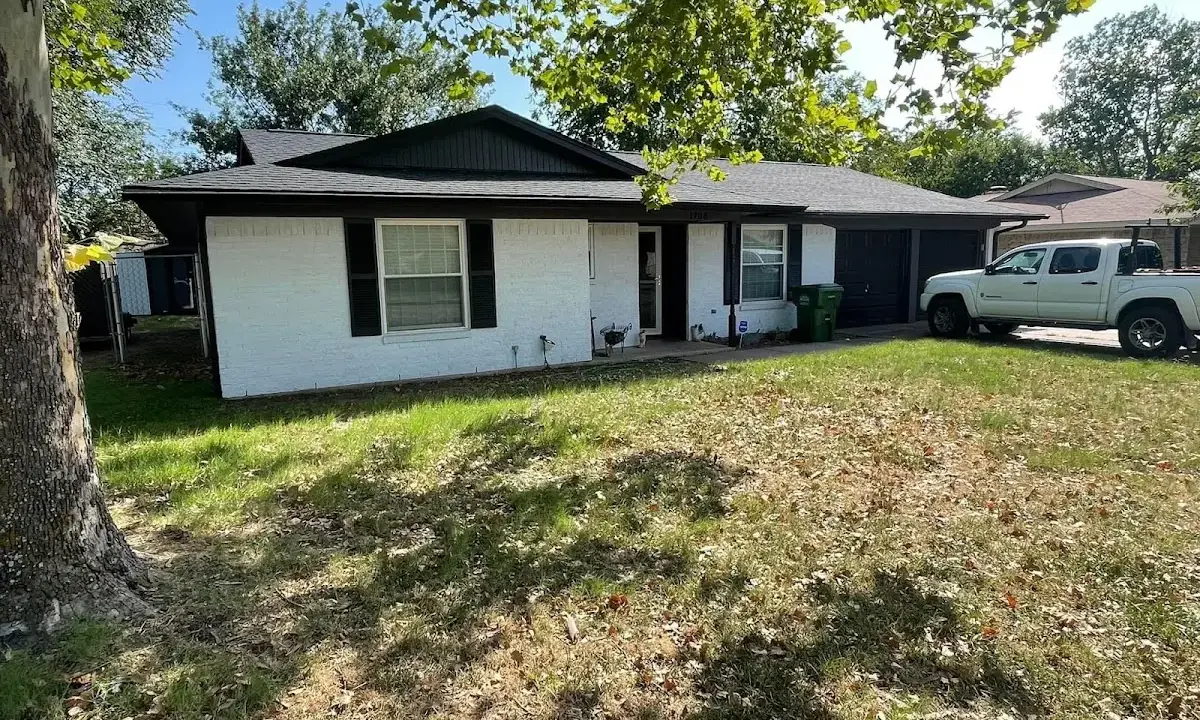 Professional roofing crew working on a residential roof in Cody